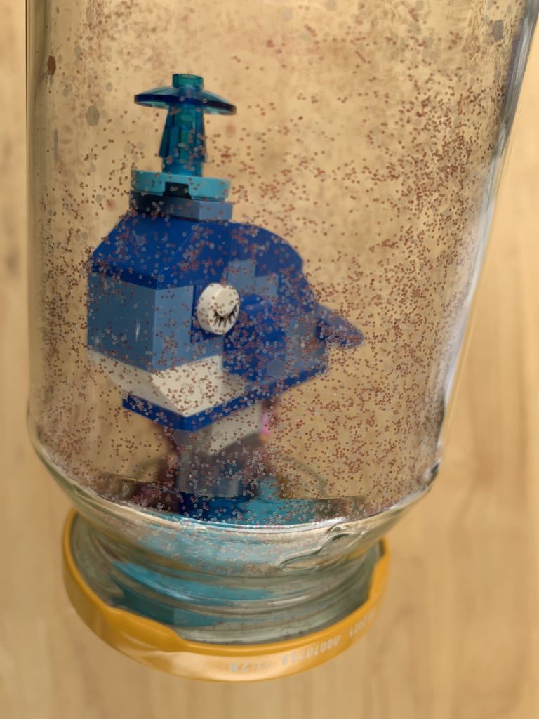Whale decoration with glitter in glass jar