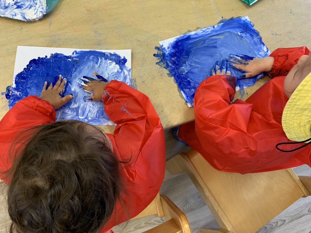 Kids painting with their hands